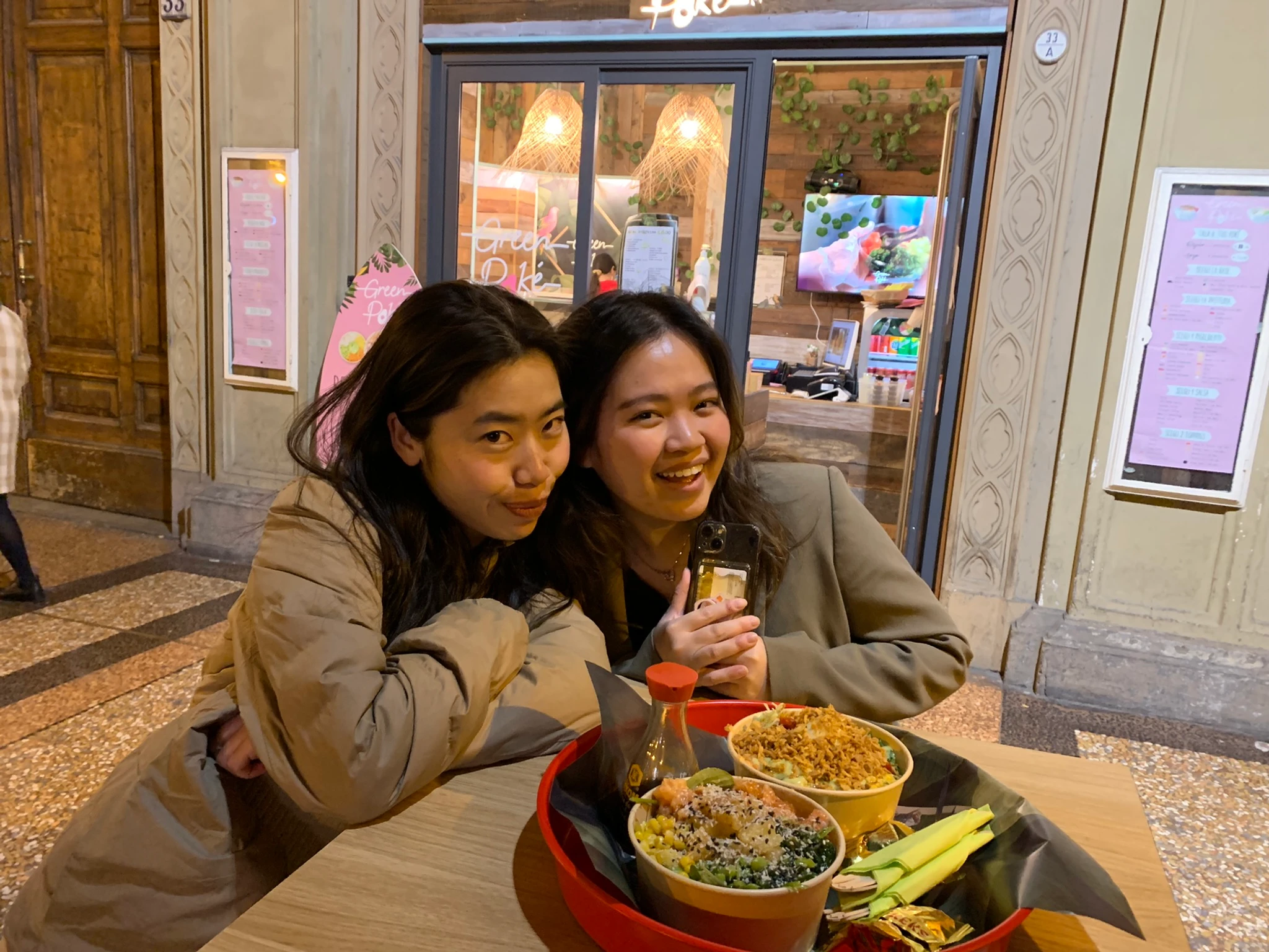 Anna and Thuan smiling over poke in Bologna.