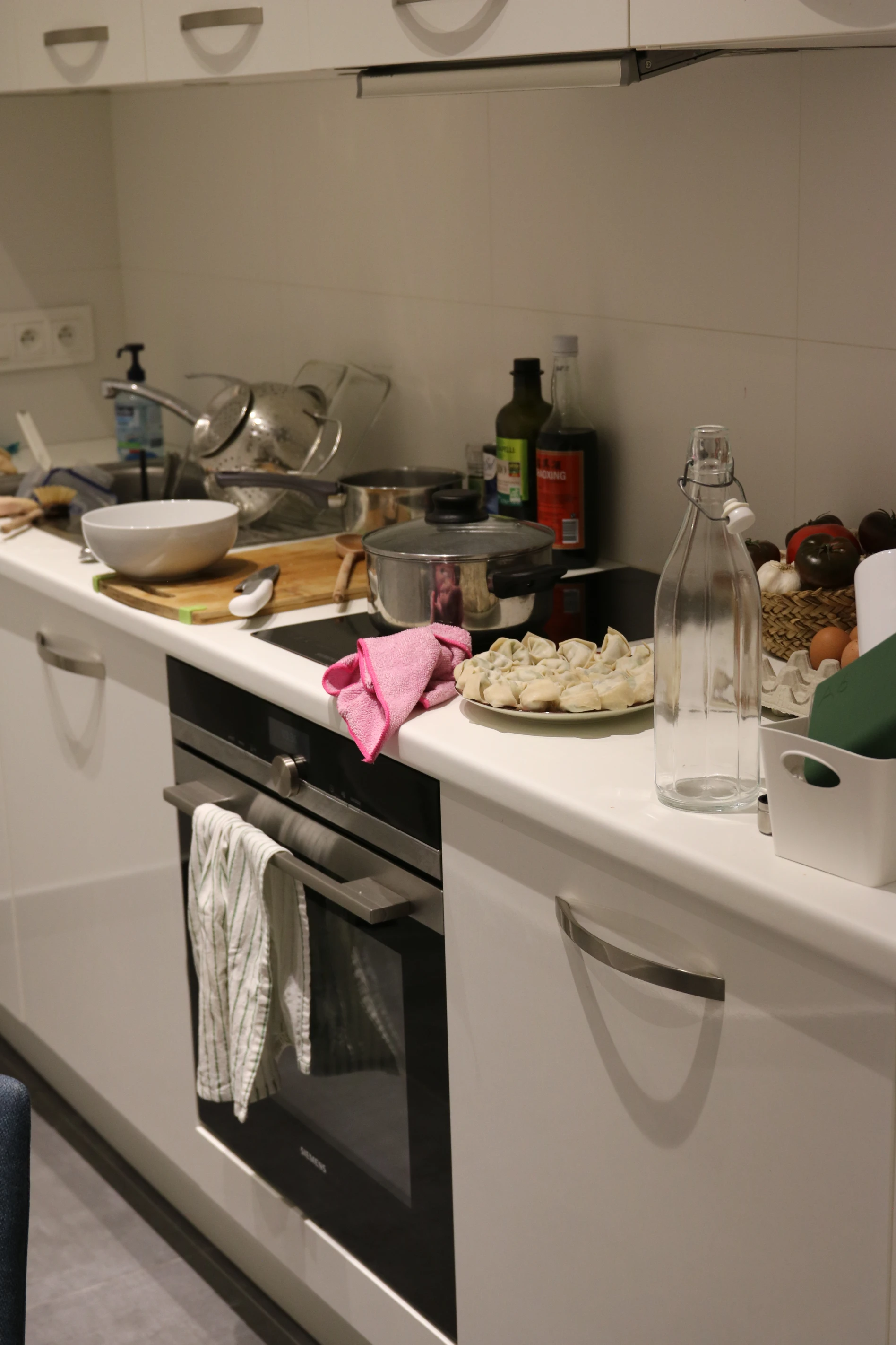 Kitchen with made wontons sitting on the counter.