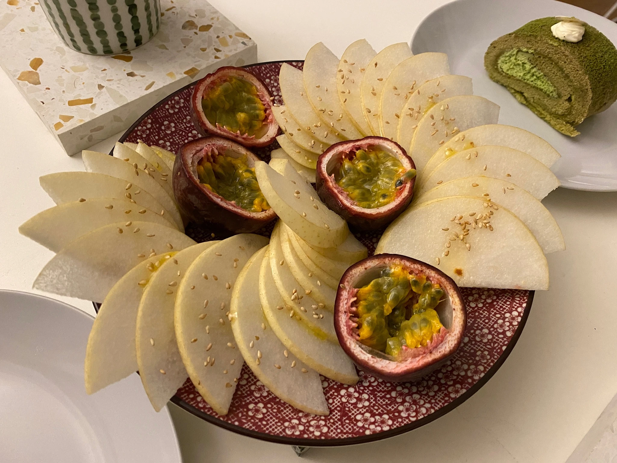 Closeup image of a fruit platter, with pears and passion fruit.
