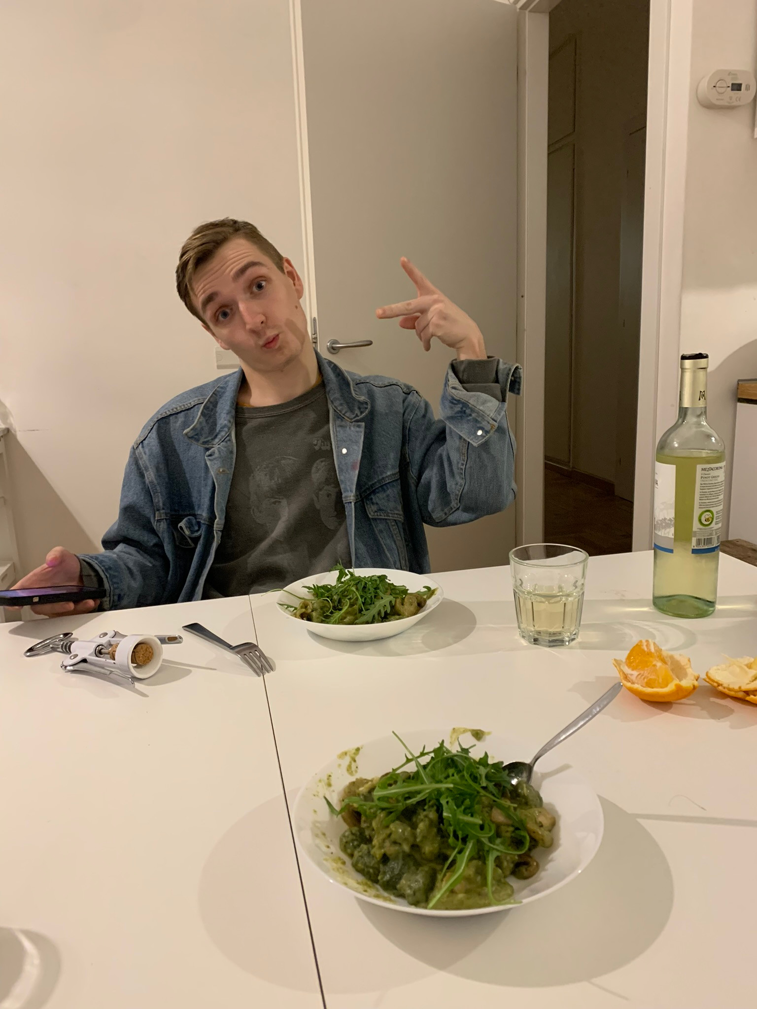 Austin and I have pesto gnocchi, white wine and oranges.