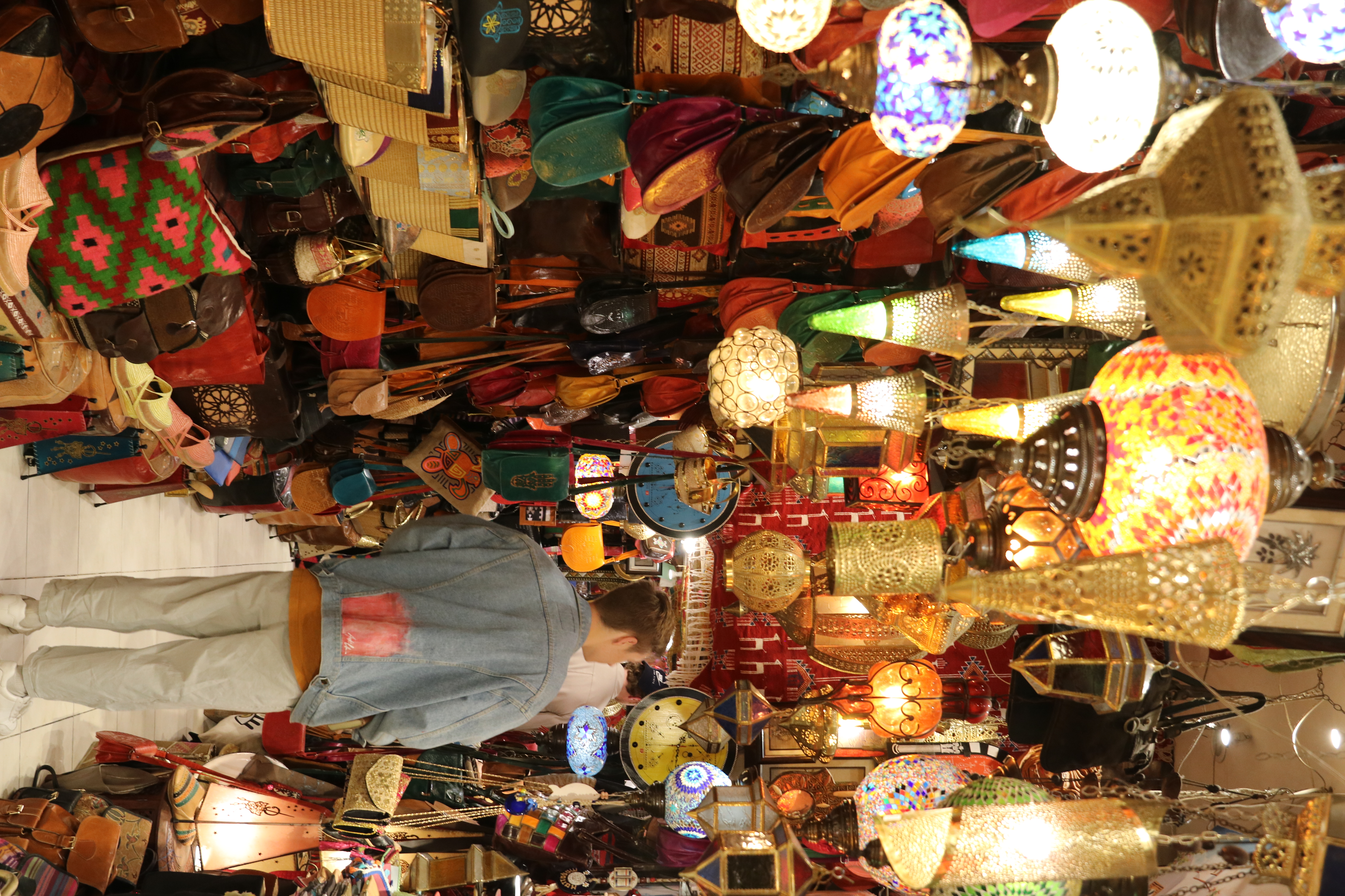 Market in Tunisia, with lamps hanging from the ceiling.