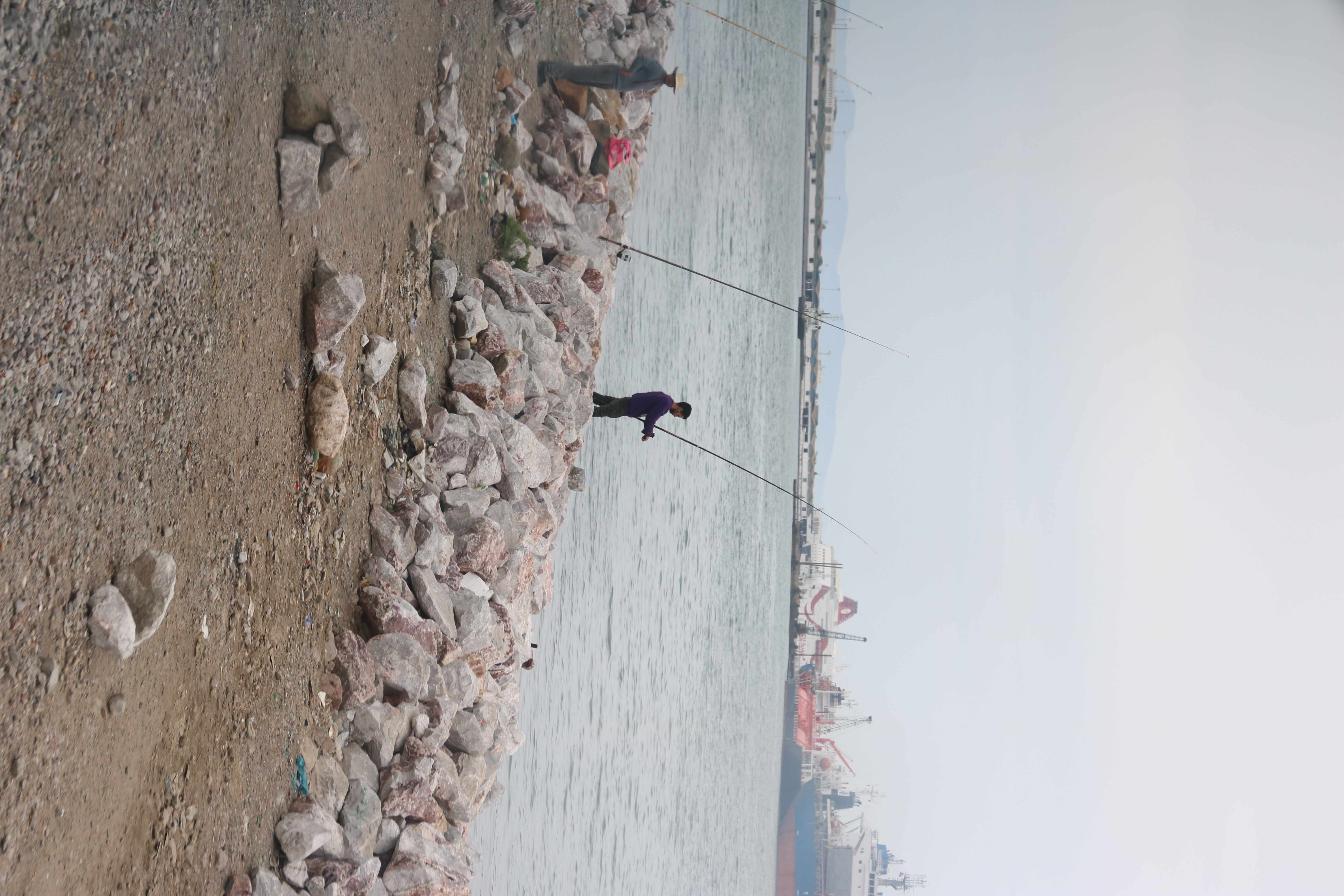 People fishing along the train tracks.