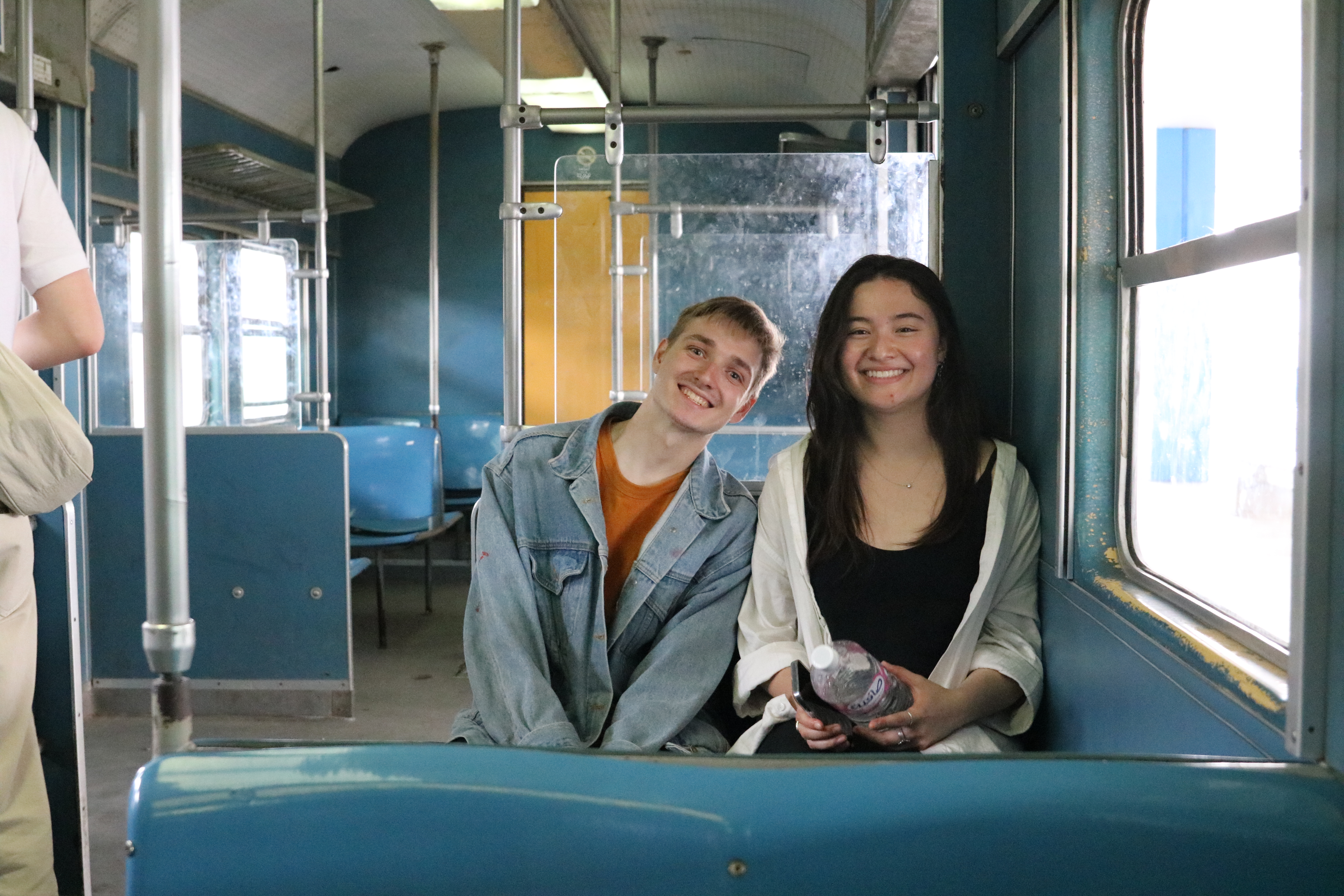Austin and Helen smiling while sitting on the train.