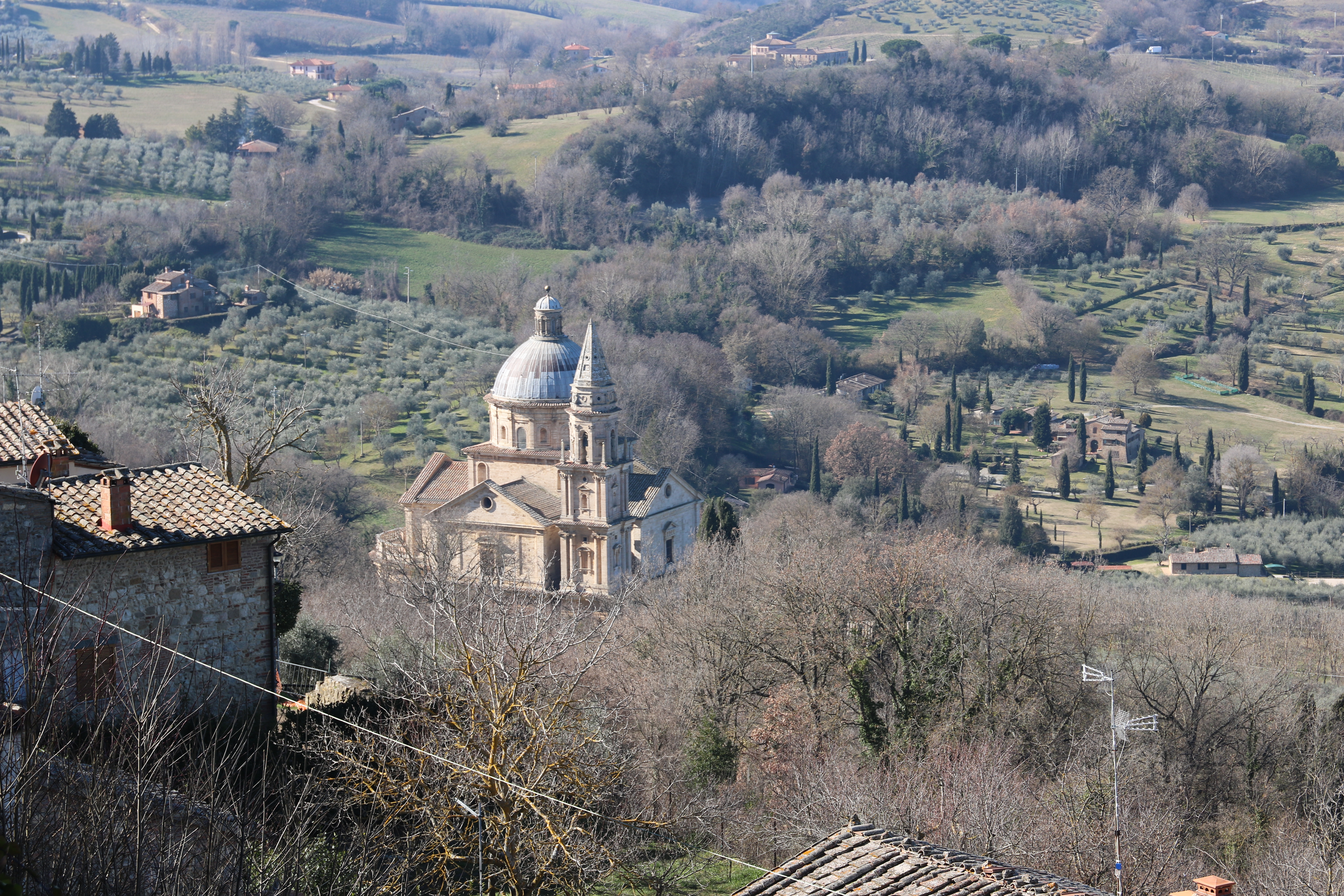 Aerial view of the Montepulciano church, surrounded by lush greenery.